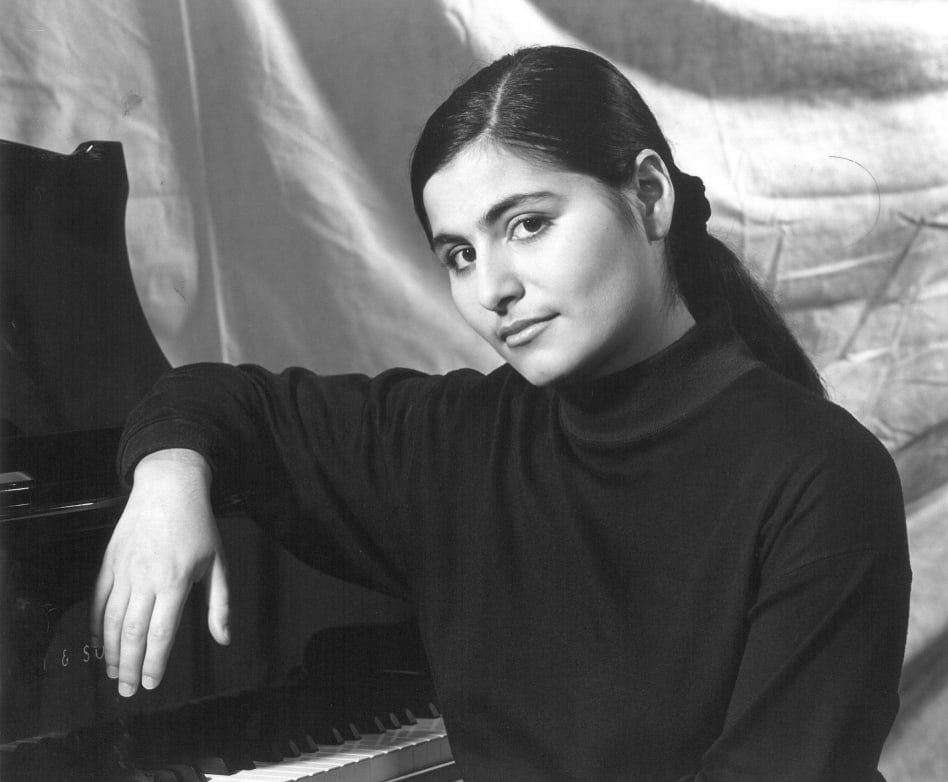 Elizaveta Kopelman leaning on piano